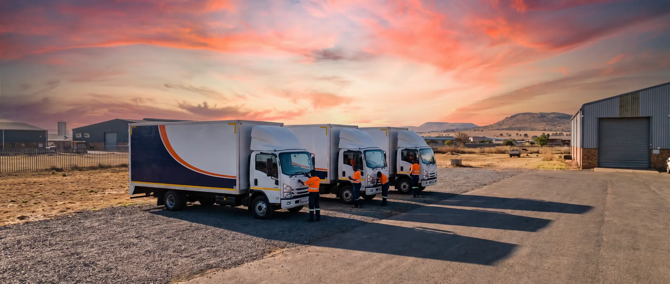 The Just In Time Removals fleet lined up in the depot yard at sunrise